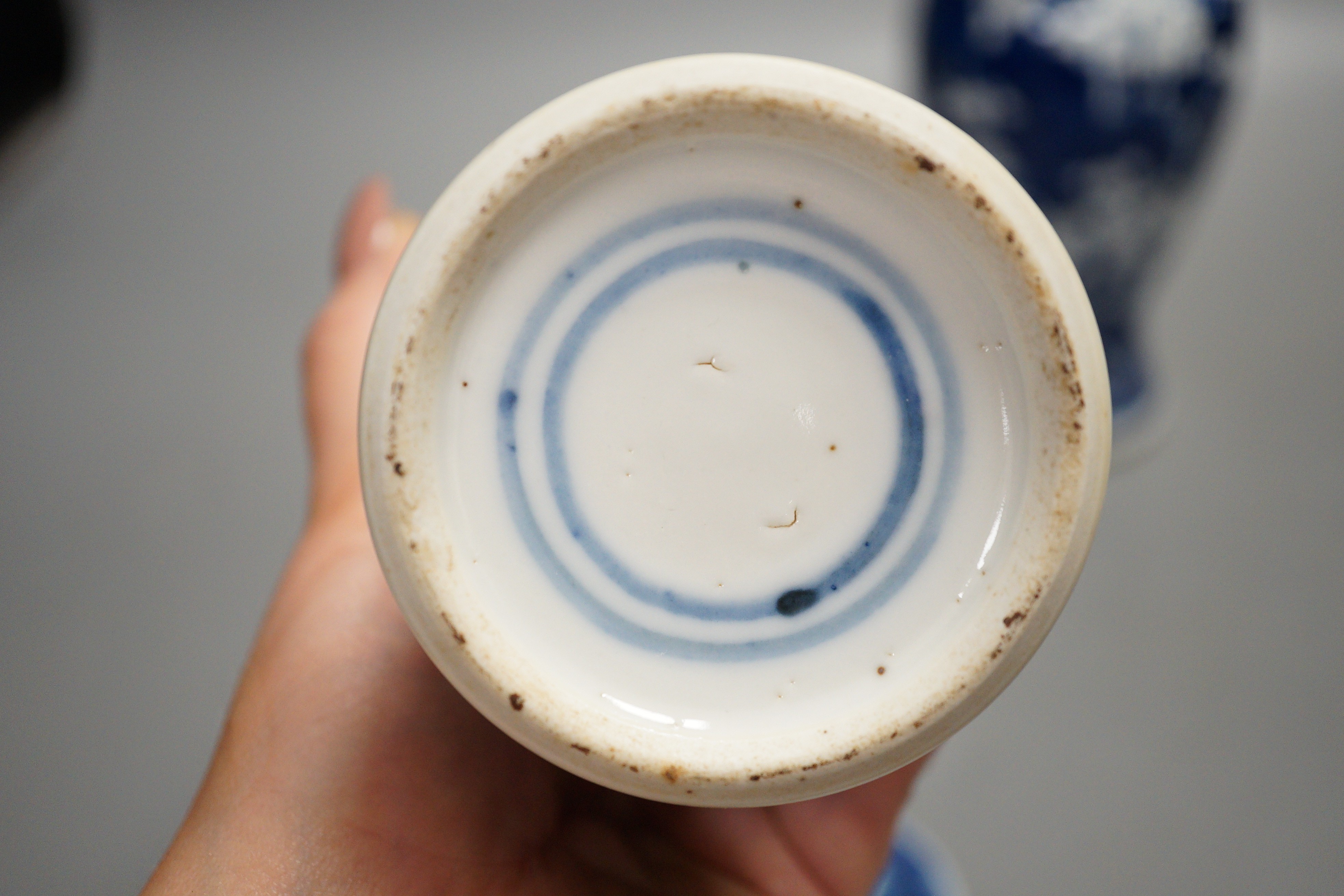 A pair of early 20th century Chinese blue and white ‘prunus’ vases and covers, 21cm